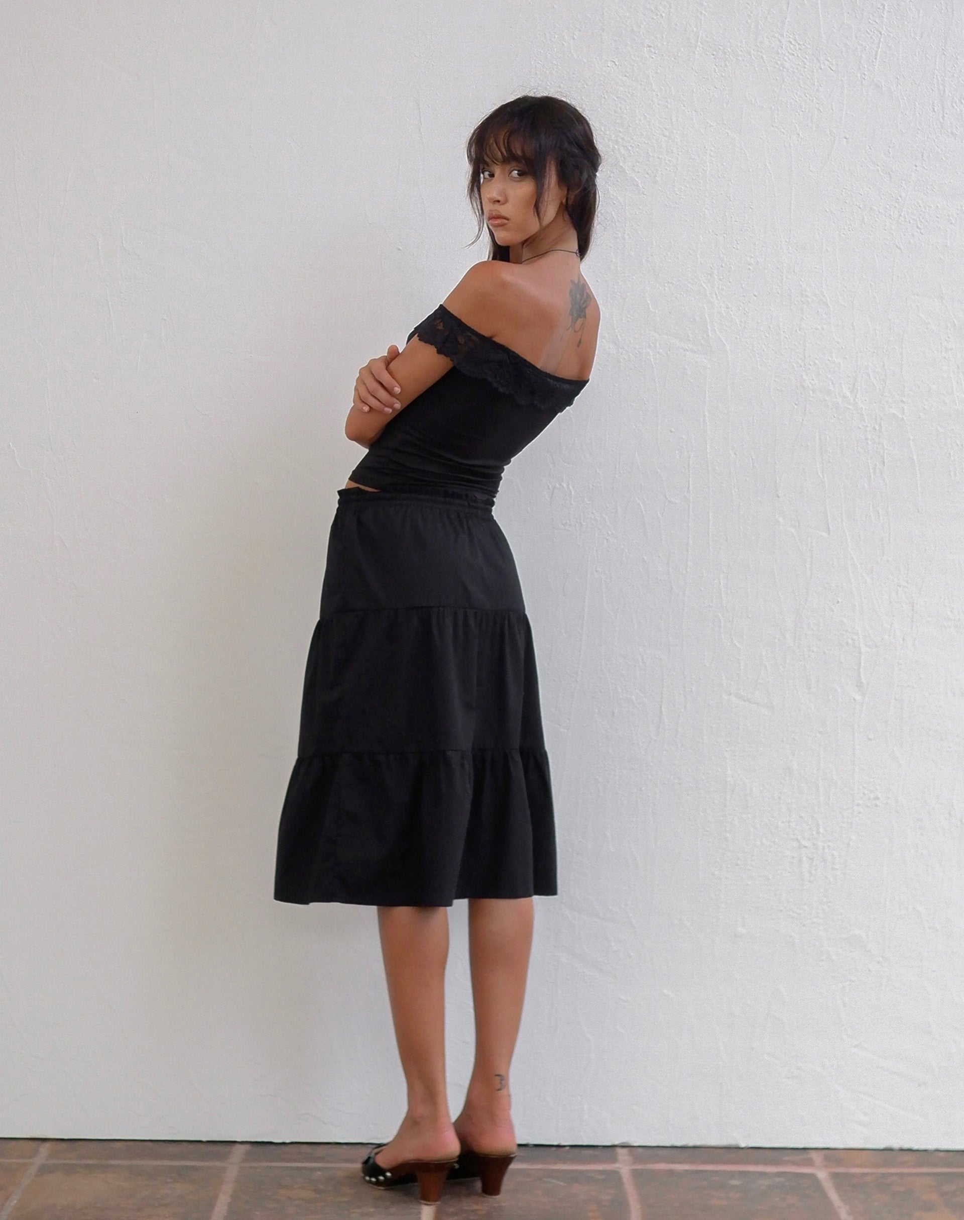Image of Nesel Bardot Top aus glitzernder Spitze Schwarz